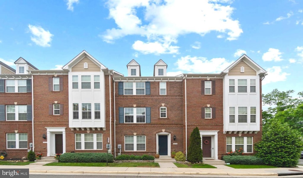 view of property featuring brick siding