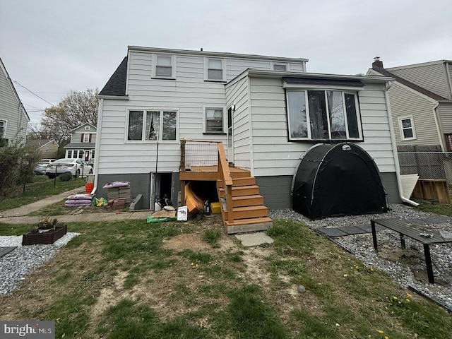 rear view of house with fence