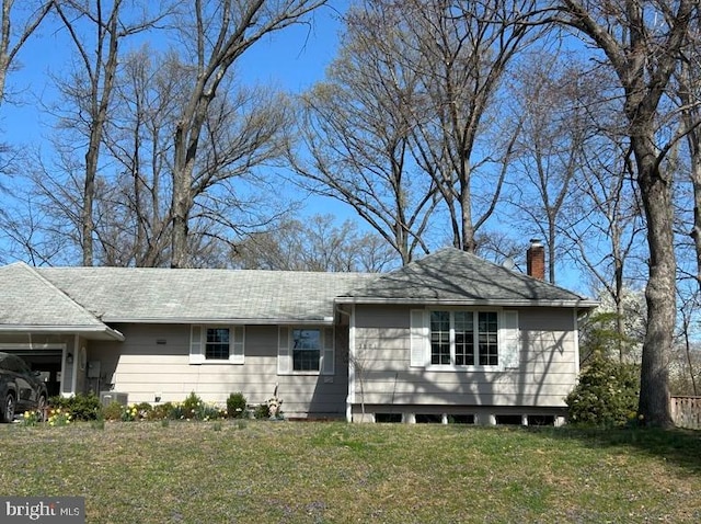 ranch-style house with a chimney and a front yard