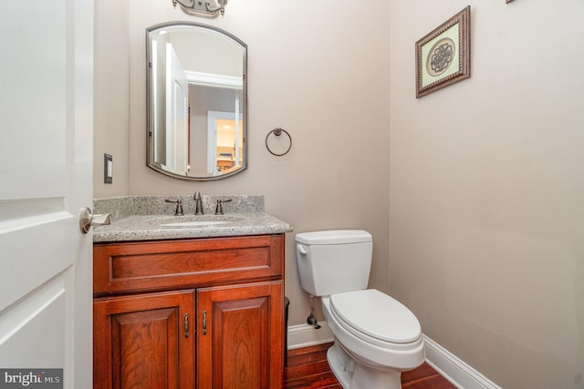 890 Hobart Rd, Hanover, PA 17331 - bathroom with toilet, vanity, wood finished floors, and baseboards