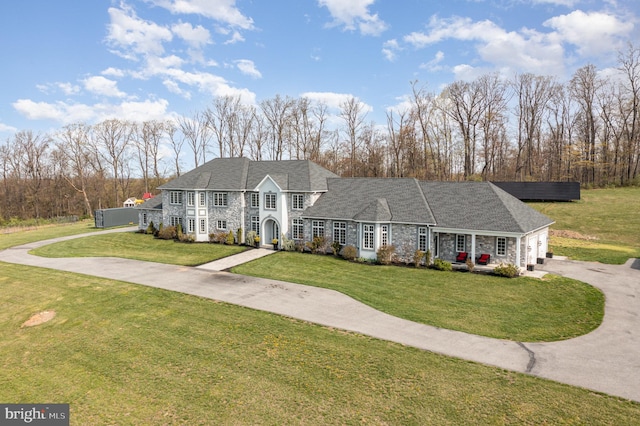 890 Hobart Rd, Hanover, PA 17331 - colonial-style house with stone siding, a front lawn, asphalt driveway, and an attached garage