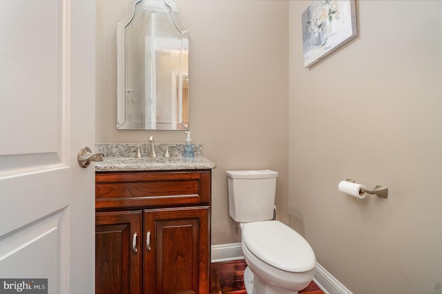890 Hobart Rd, Hanover, PA 17331 - bathroom with toilet, vanity, baseboards, and wood finished floors
