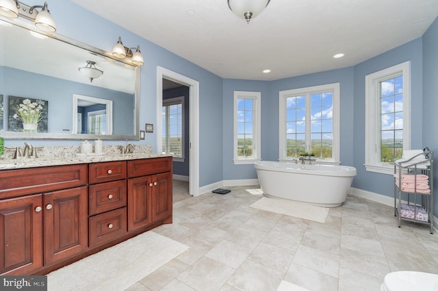 890 Hobart Rd, Hanover, PA 17331 - full bathroom with double vanity, a soaking tub, baseboards, and recessed lighting