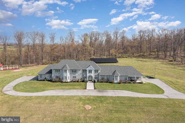 890 Hobart Rd, Hanover, PA 17331 - view of front of home featuring a front lawn, solar panels, stone siding, and a view of trees
