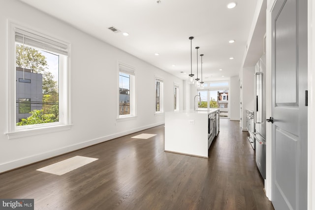 kitchen featuring a healthy amount of sunlight, light countertops, a sink, and visible vents