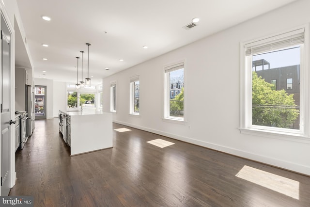 kitchen with visible vents, pendant lighting, light countertops, freestanding refrigerator, and recessed lighting