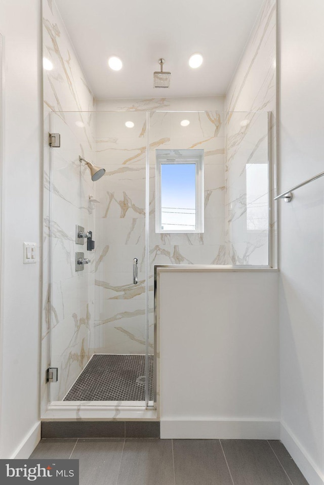 full bathroom with a marble finish shower, baseboards, and recessed lighting
