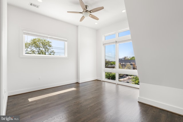 unfurnished room featuring ceiling fan, visible vents, dark wood finished floors, baseboards, and recessed lighting