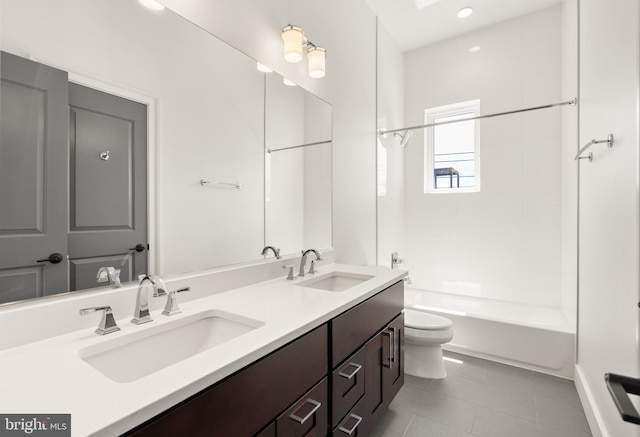 full bathroom featuring a sink, tile patterned flooring, toilet, and double vanity