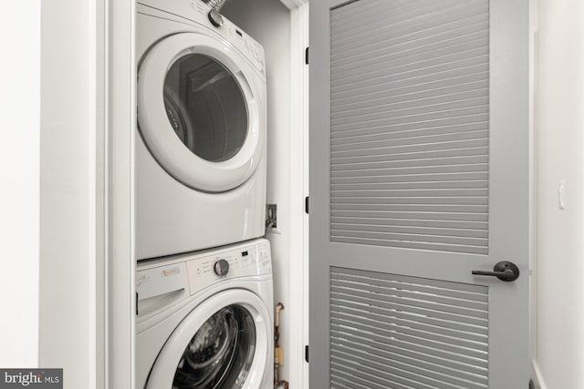 laundry area with laundry area and stacked washer / drying machine