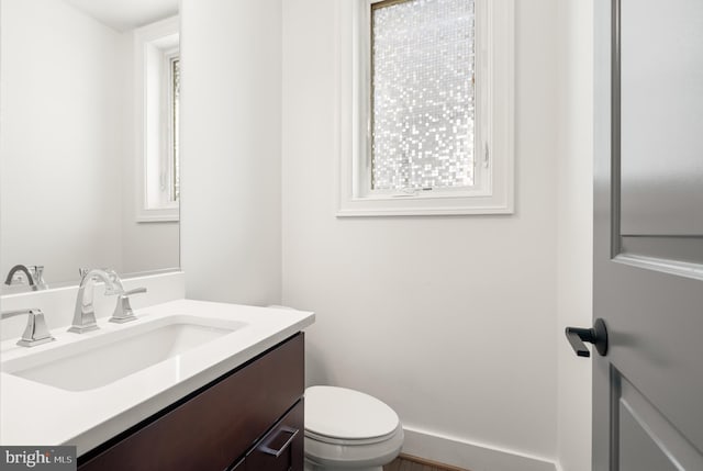 half bath with vanity and toilet