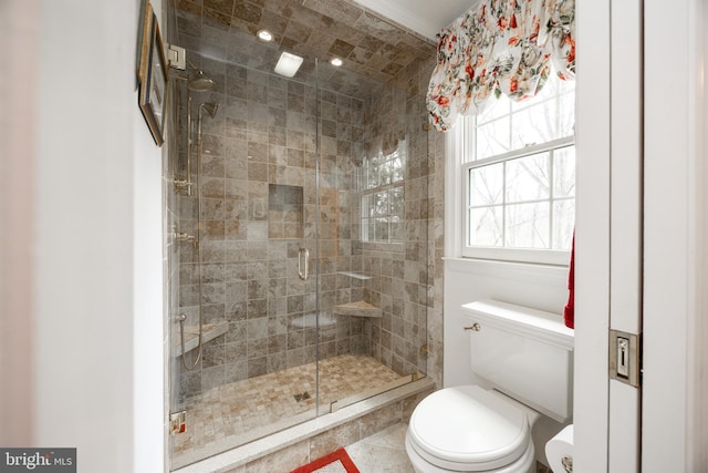 bathroom featuring a shower stall and toilet