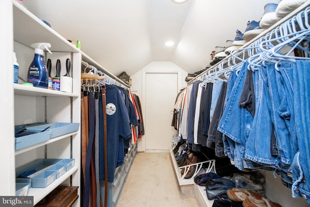 spacious closet with vaulted ceiling and carpet floors