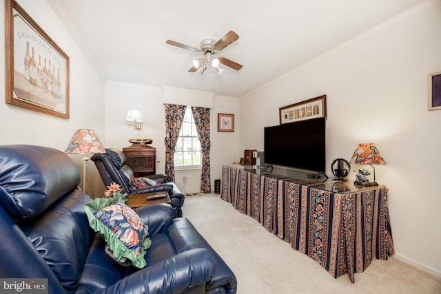 carpeted living area with ceiling fan and crown molding