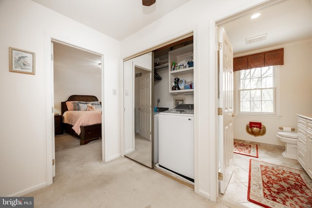 laundry room featuring laundry area, visible vents, a ceiling fan, light carpet, and washer / dryer