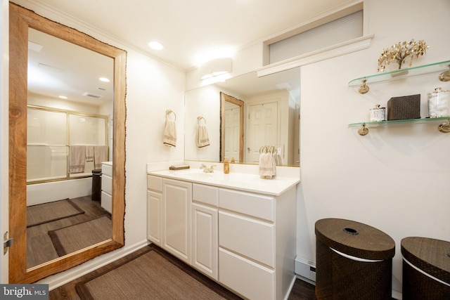 bathroom featuring combined bath / shower with glass door, wood finished floors, vanity, and recessed lighting