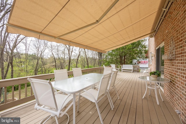 wooden terrace with outdoor dining area