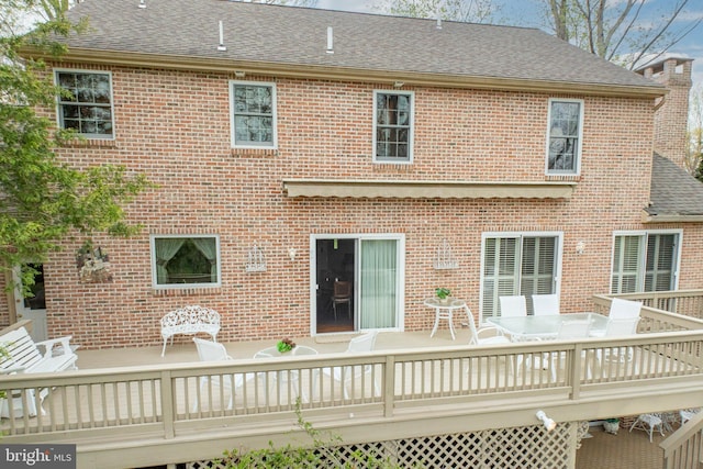 back of house with a wooden deck and brick siding