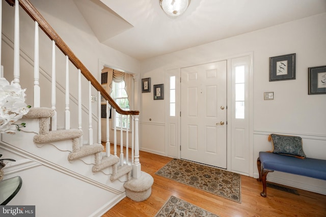 foyer entrance with stairway and wood finished floors