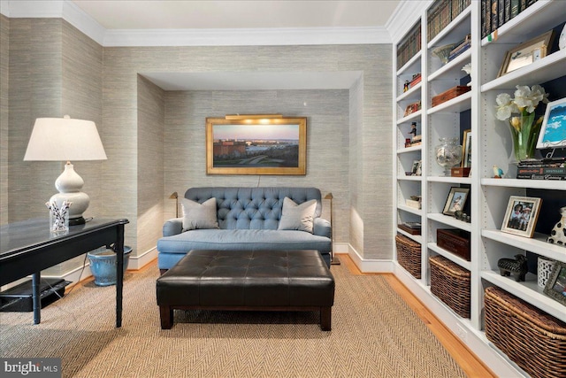 sitting room with crown molding and wood finished floors