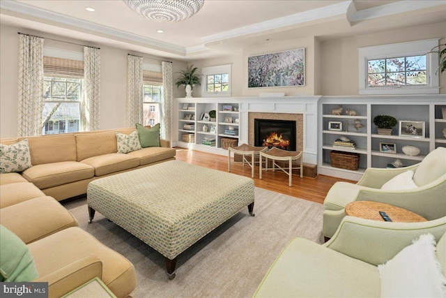 living area with a fireplace, wood finished floors, plenty of natural light, and recessed lighting