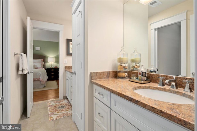 bathroom with tile patterned flooring, visible vents, connected bathroom, and vanity