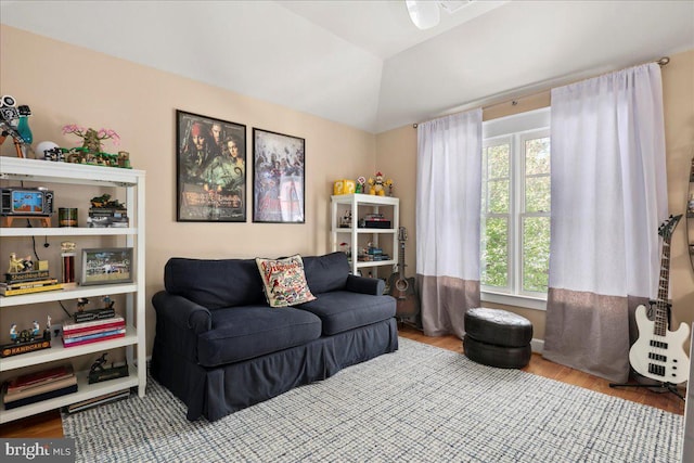 sitting room with lofted ceiling and wood finished floors