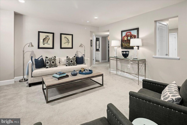 living area featuring recessed lighting, light carpet, and baseboards