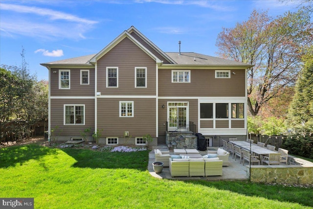rear view of house featuring an outdoor living space, a lawn, and a patio