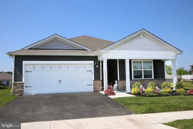 185 Petal Dr, Pottstown, PA 19464 - view of front facade with an attached garage, driveway, a porch, roof with shingles, and a front yard