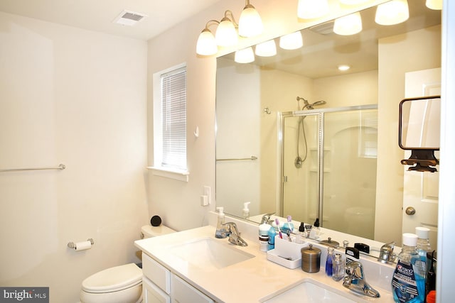 185 Petal Dr, Pottstown, PA 19464 - full bathroom with double vanity, visible vents, toilet, a sink, and a stall shower