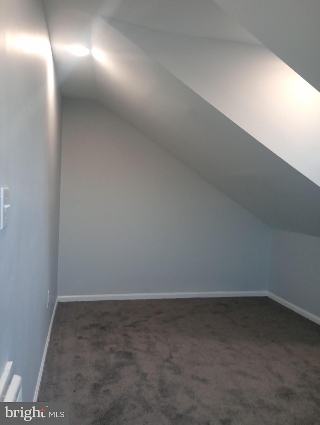 bonus room featuring carpet floors, lofted ceiling, and baseboards