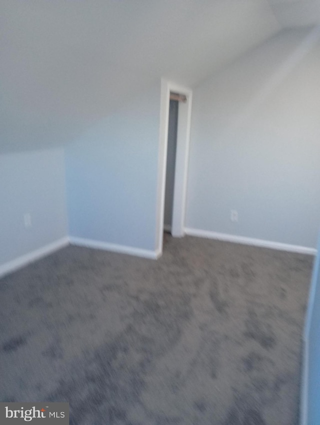 bonus room with lofted ceiling, carpet floors, and baseboards