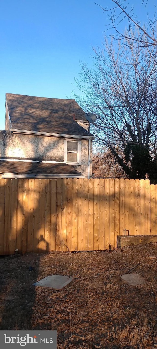 view of home's exterior with fence