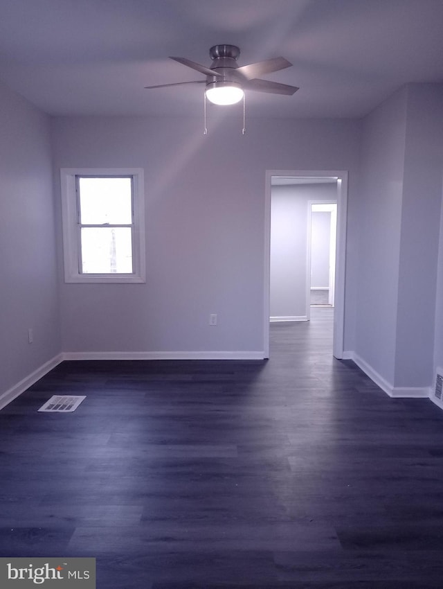 bonus room featuring dark wood finished floors, baseboards, a ceiling fan, and visible vents
