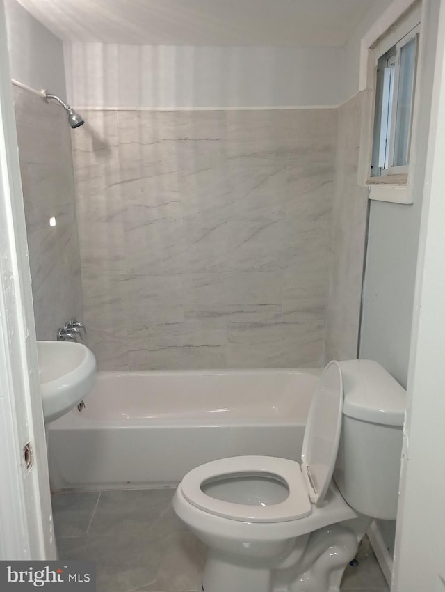 bathroom featuring bathing tub / shower combination and toilet