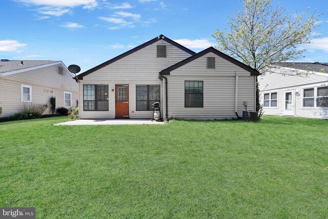 rear view of house featuring a yard, a patio area, and central AC