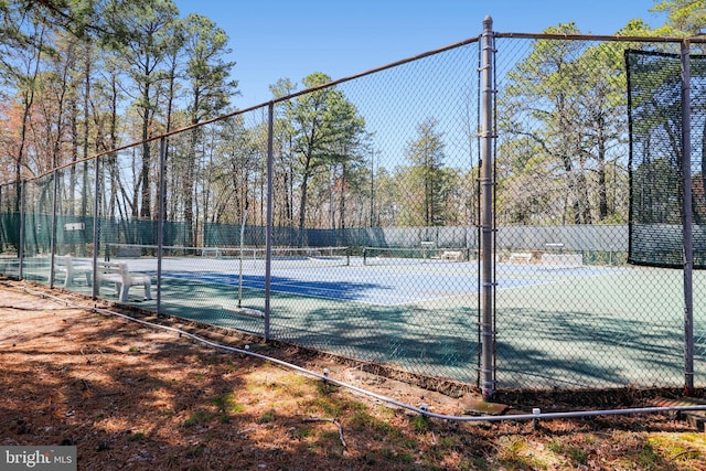 view of tennis court featuring fence