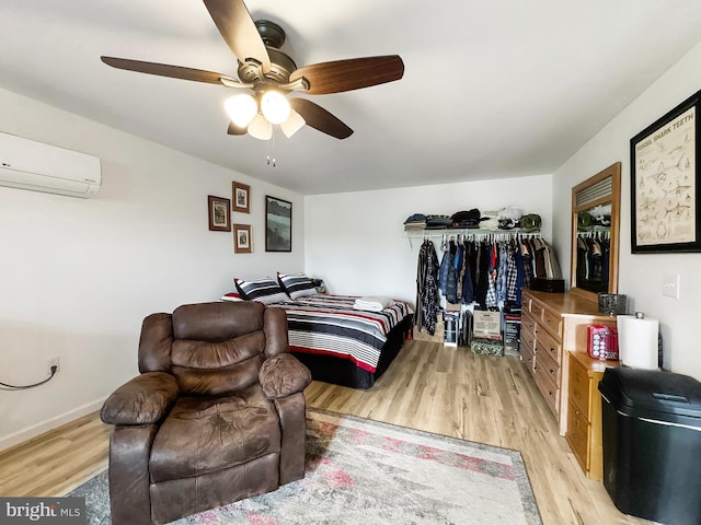 353 Kerrsville Rd, Carlisle, PA 17015 - bedroom featuring baseboards, light wood-style floors, a wall mounted air conditioner, a ceiling fan, and a closet
