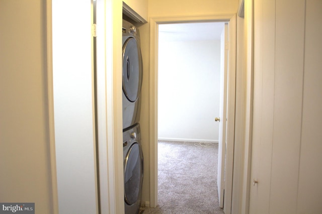 1105 Castle Harbour Way Unit 2B, Glen Burnie, MD 21060 - laundry room featuring carpet floors, stacked washer and dryer, baseboards, and laundry area