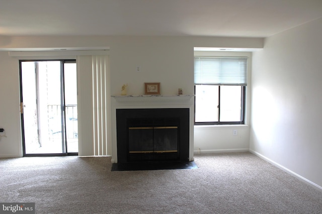 1105 Castle Harbour Way Unit 2B, Glen Burnie, MD 21060 - carpeted living room featuring a fireplace with flush hearth, baseboards, and a wealth of natural light