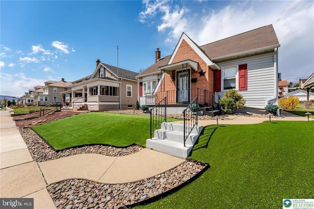 view of front of property with a front lawn and brick siding