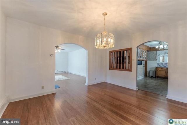 unfurnished dining area with arched walkways, ceiling fan with notable chandelier, baseboards, wood finished floors, and a baseboard heating unit