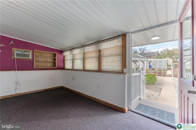unfurnished sunroom with an AC wall unit
