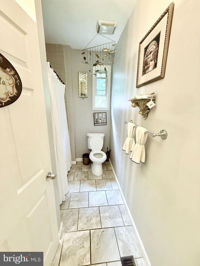 4006 Chesmont Ave, Baltimore, MD 21206 - bathroom featuring toilet, a shower with shower curtain, and baseboards