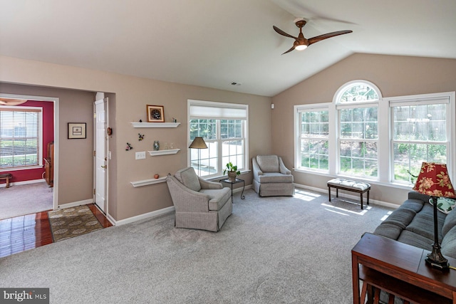 living room with vaulted ceiling, plenty of natural light, carpet, and a ceiling fan