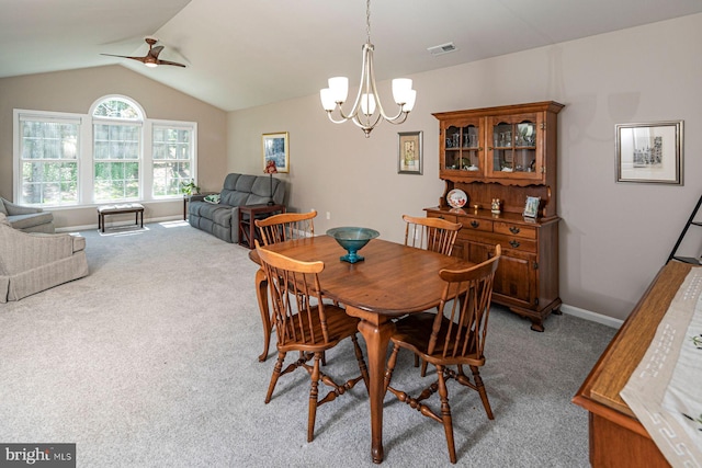 dining space featuring light colored carpet, baseboards, ceiling fan with notable chandelier, and lofted ceiling
