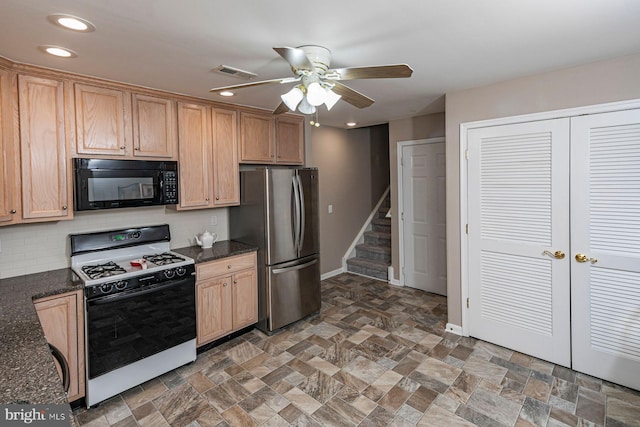 kitchen with decorative backsplash, ceiling fan, black microwave, freestanding refrigerator, and gas range oven