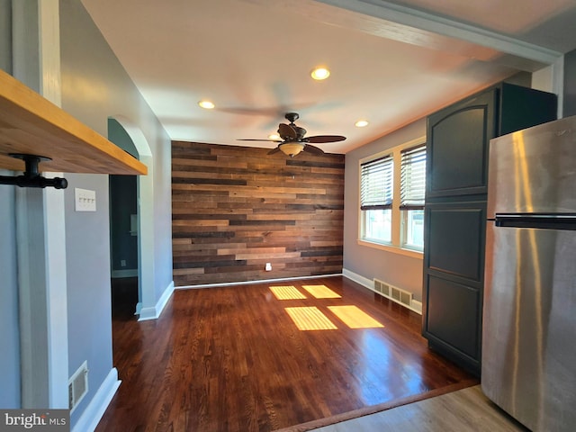 8464 Geneva Rd, Pasadena, MD 21122 - unfurnished dining area with ceiling fan, wood walls, recessed lighting, baseboards, and dark wood finished floors