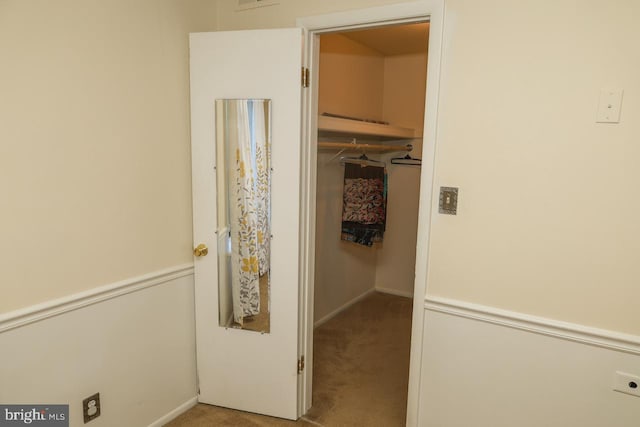 corridor with carpet and baseboards